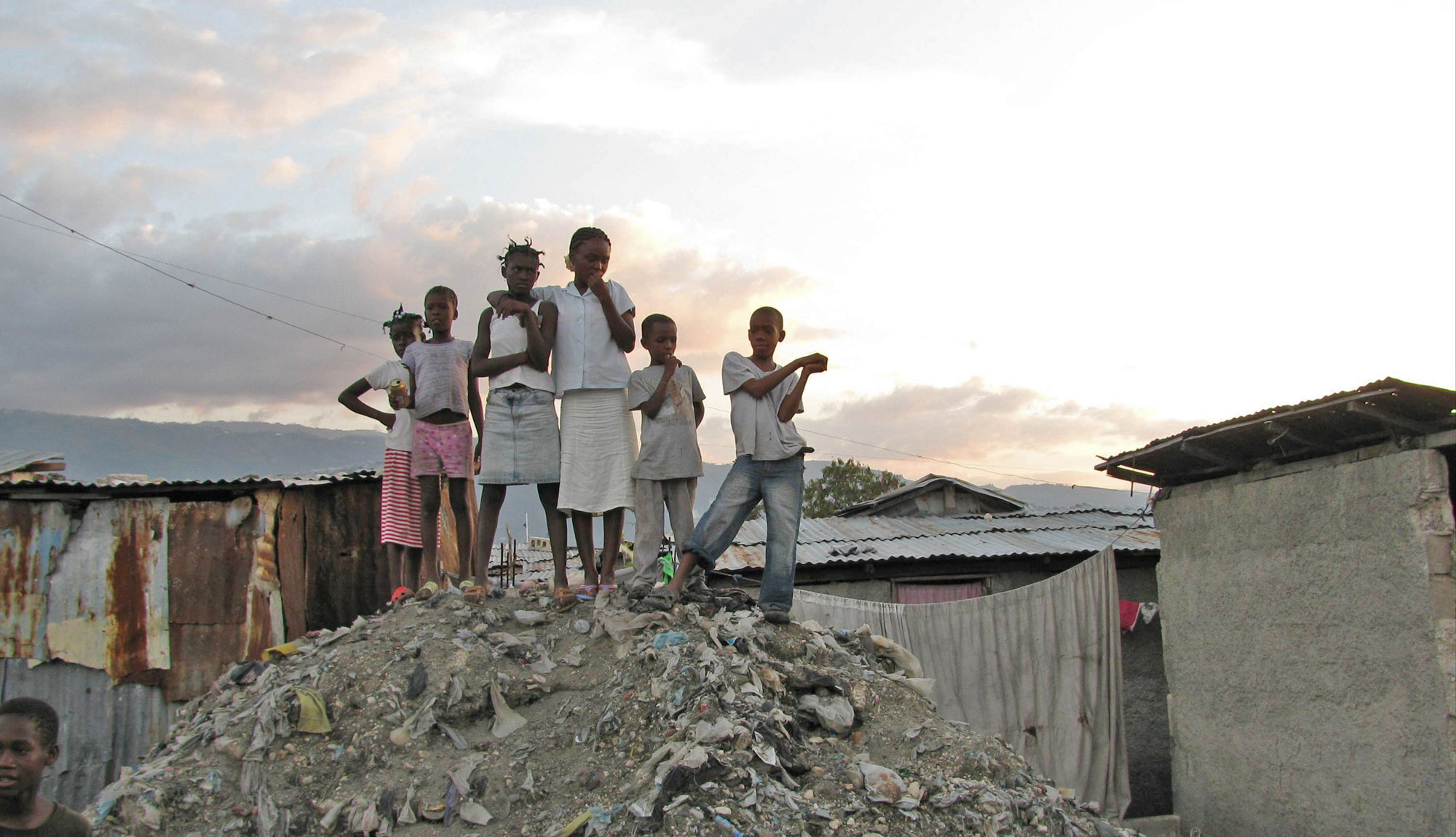 Children in Haiti on rubble